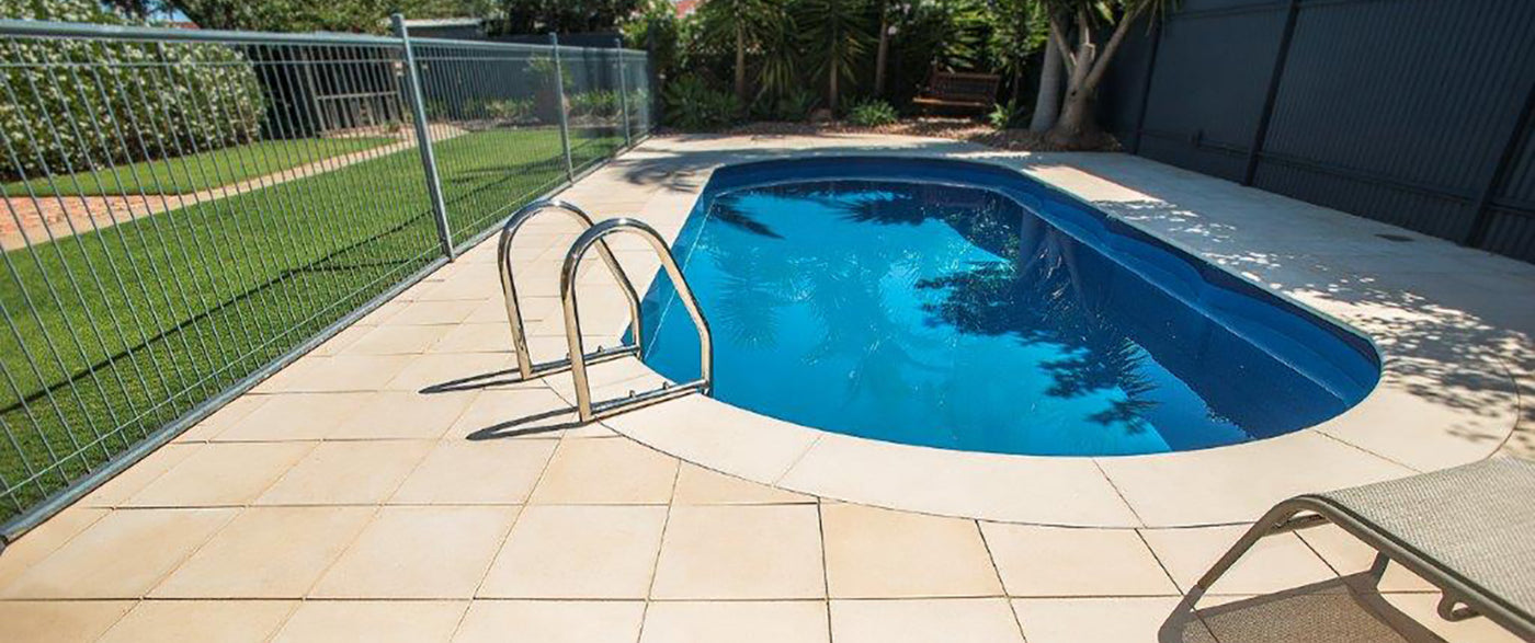 a in ground swimming pool with a fence surrounding it